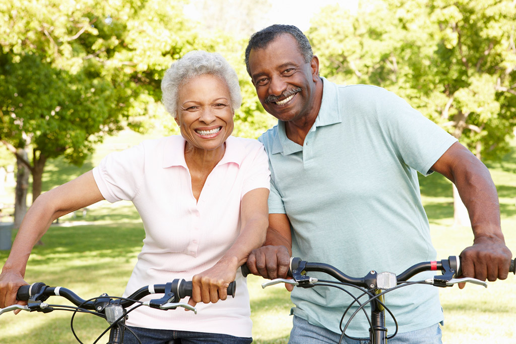 A man and woman stopped together while riding their bikes