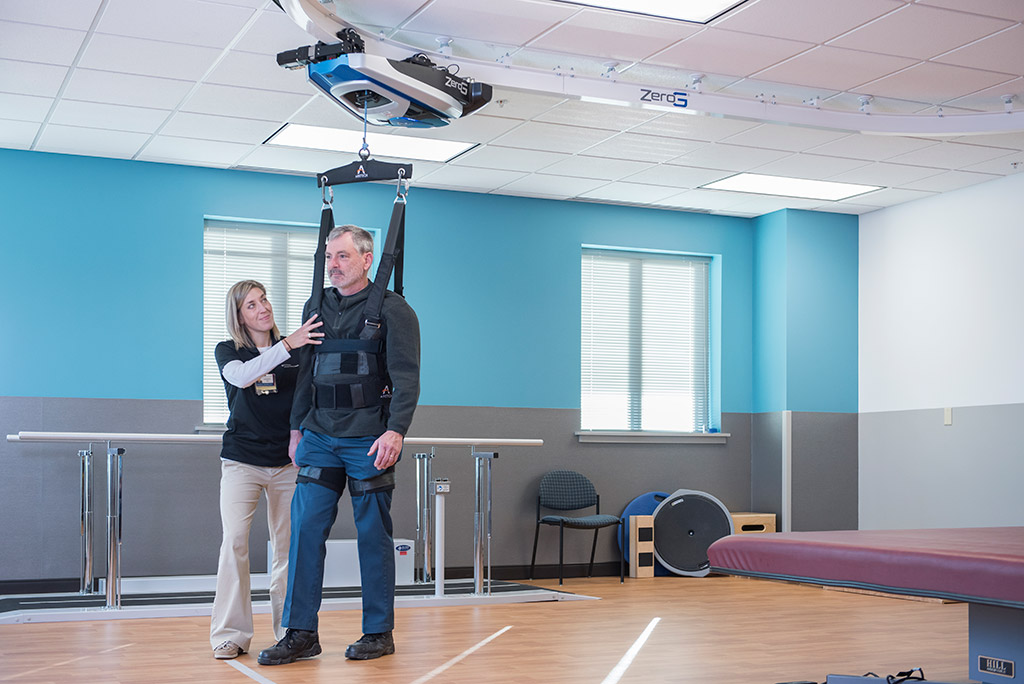 Lancaster General Health Neuroscience Institute ZeroG Gait and Balance System A nurse assisting a patient in the ZeroG gait and balance system